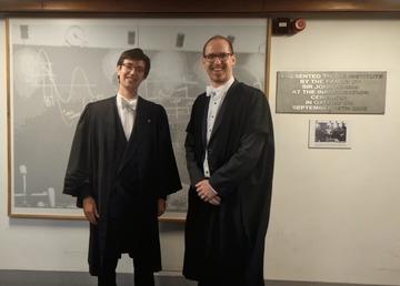 Seb Wilkes and Prof. Adrian Oeftiger standing, smiling in formalwear