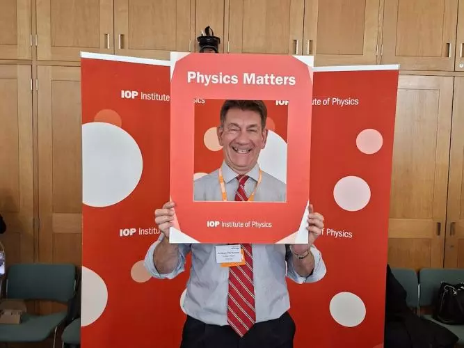 Philip Burrows smiling with Physics Matters